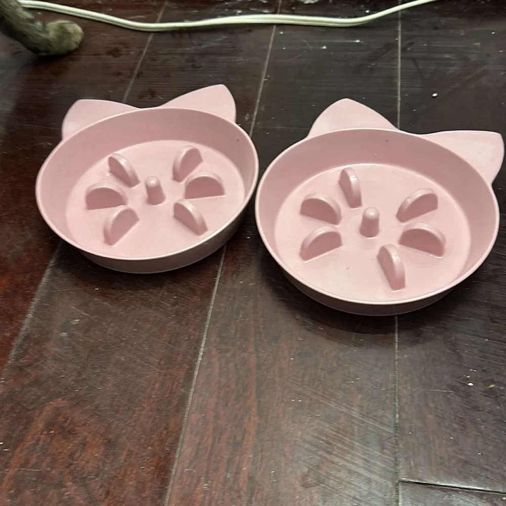 2 pink cat food bowls